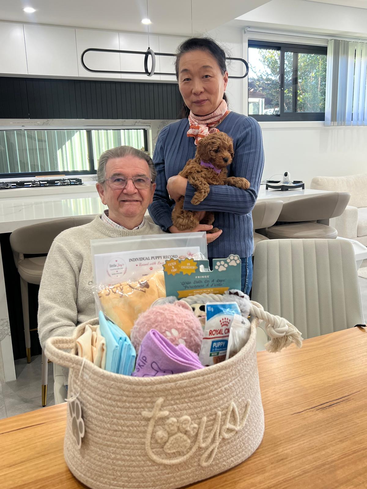 A family collecting their Little Joy puppy with their puppy pack